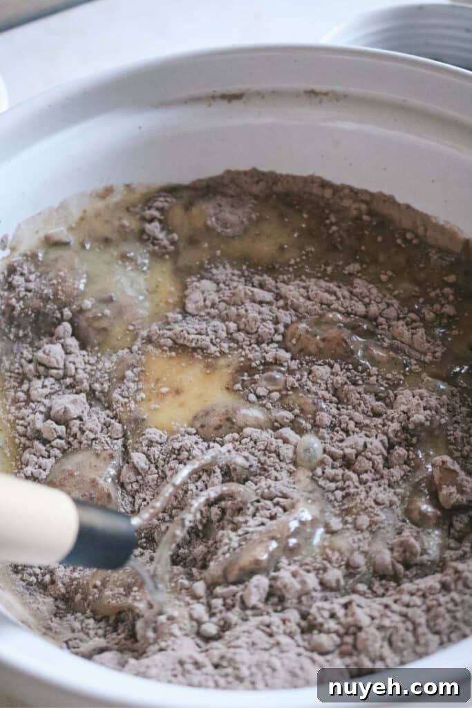 mixing wet and dry ingredients for brownie batter.