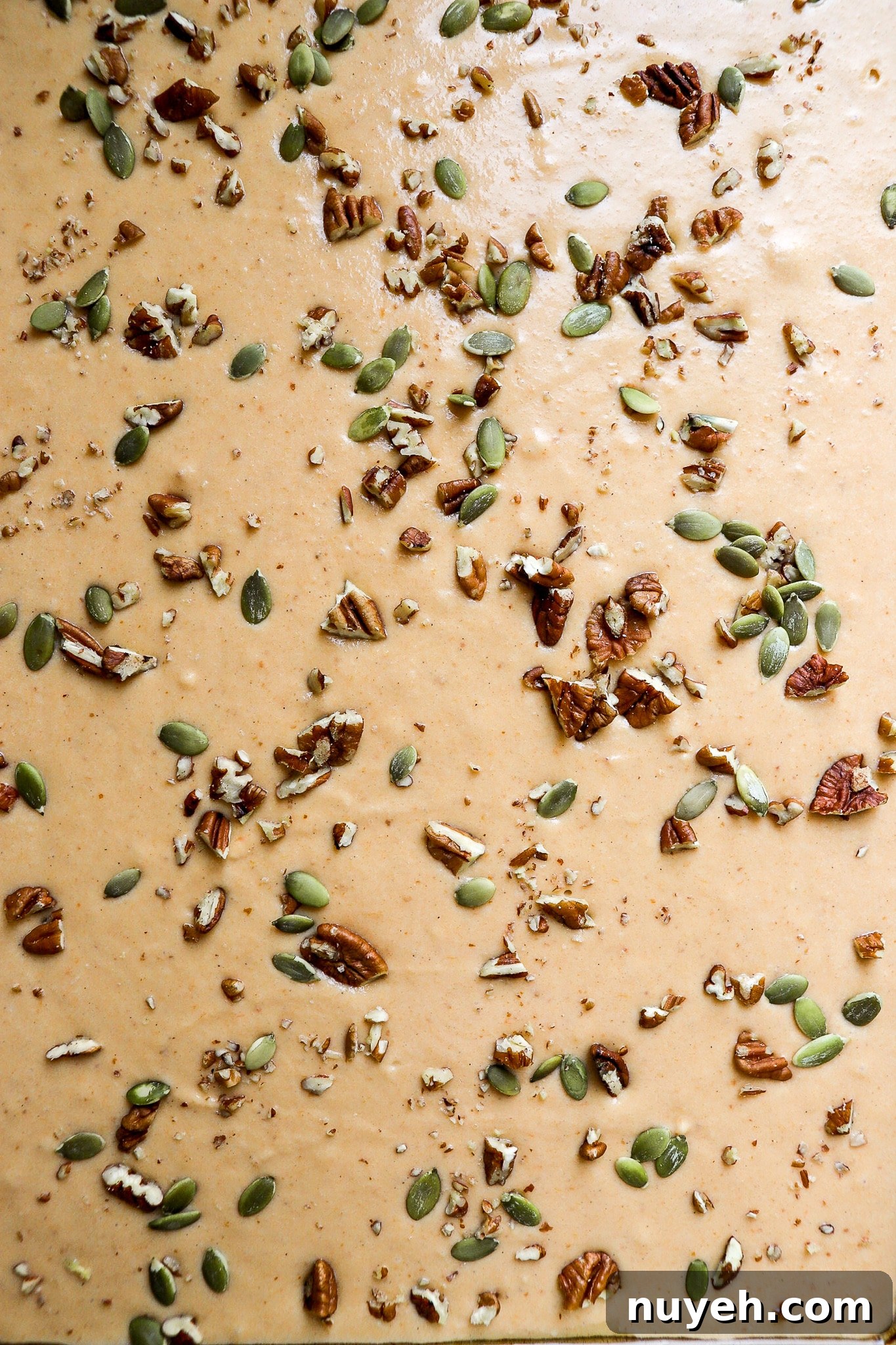 close up shot of pumpkin sheet pan pancake batter on baking sheet