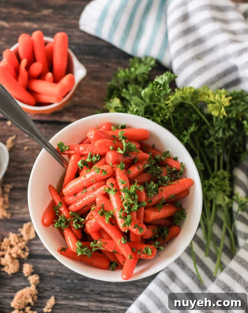 Cooked carrots glazed with brown sugar, butter and mustard with parsley garnish.