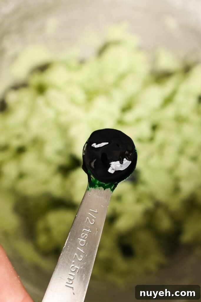 Food coloring being added to dough.