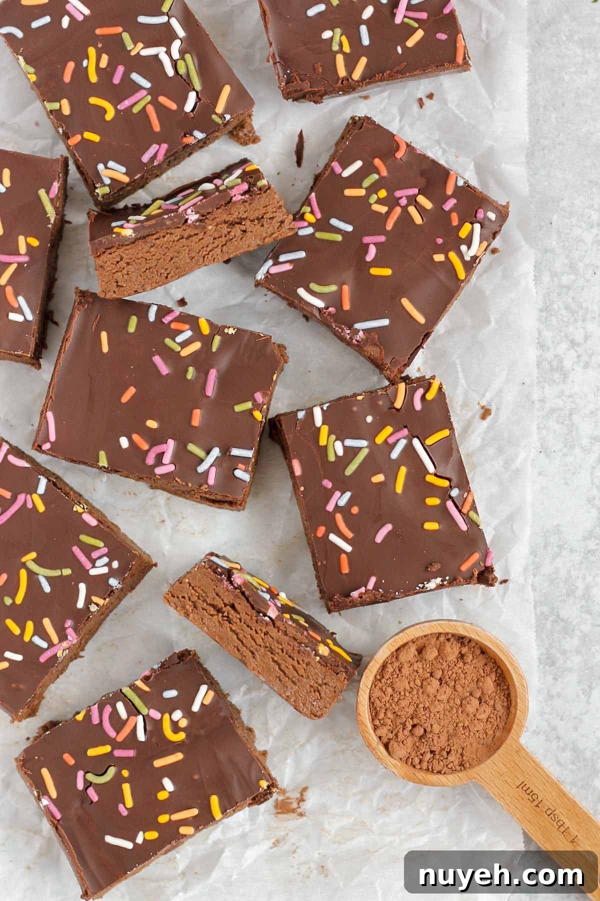 Cut up chocolate protein bars on crinkled white parchment paper.