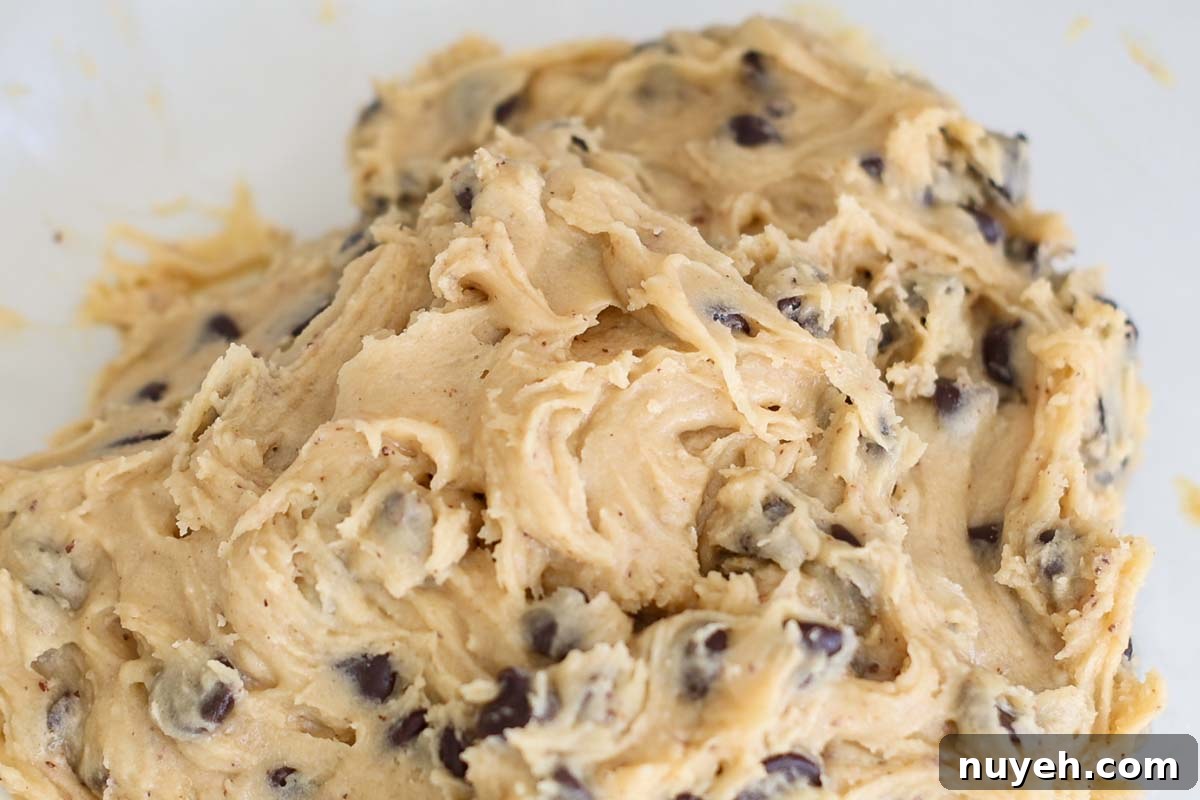 Cookie dough inside a transparent glass bowl.