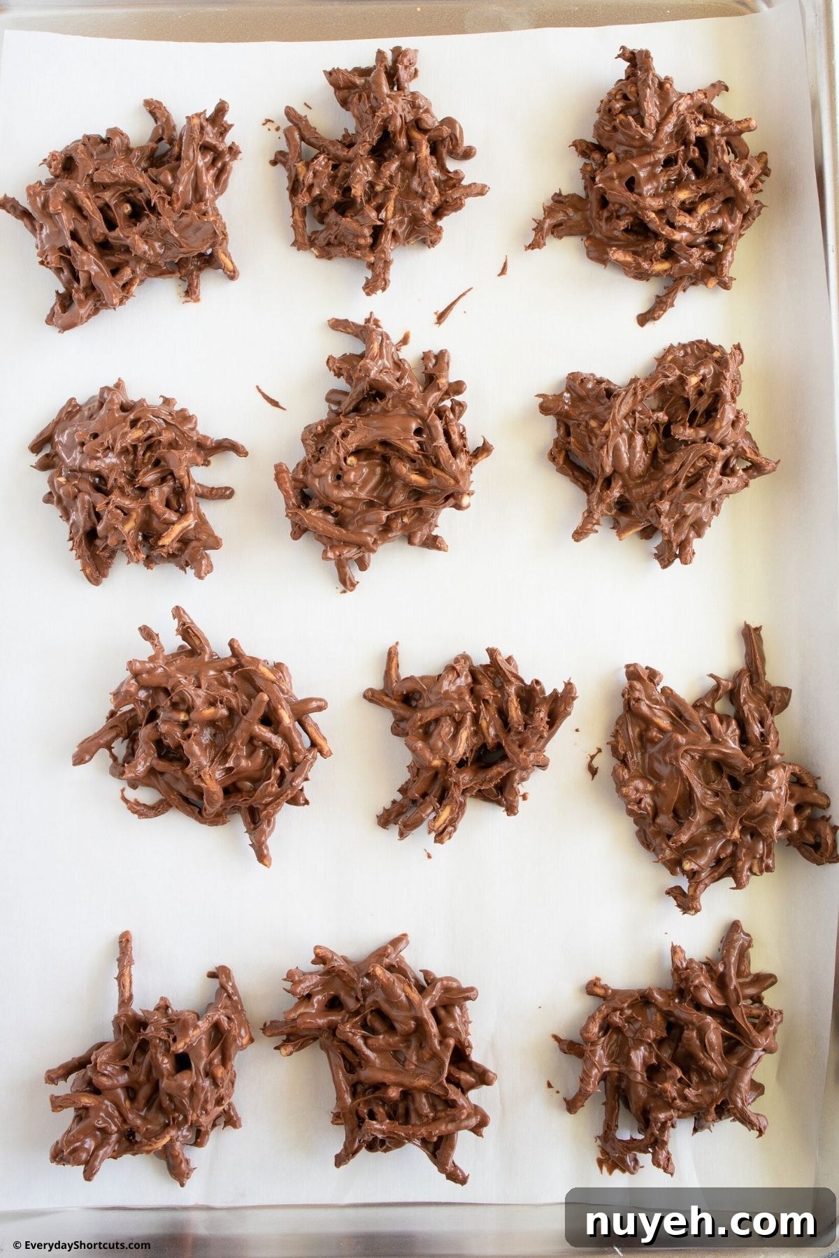 Homemade Birds Nest Cookies with Chocolate Eggs 6 haystack cookies on parchment paper