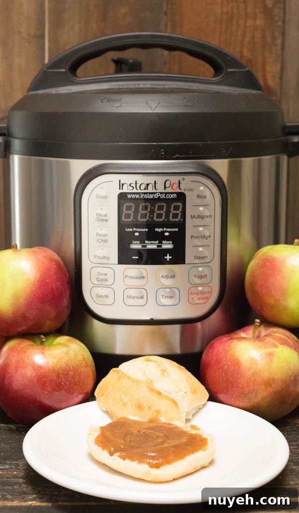 Apple butter on a roll in front of the Instant Pot.