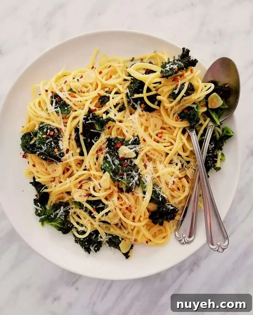 spicy kale pasta topped with parmesan cheese and red pepper flakes overhead