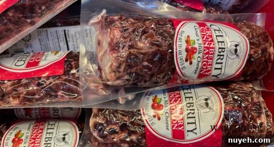Celebrity Cranberry Goat Cheese log from Costco sliced with crackers — festive Costco Thanksgiving appetizer.