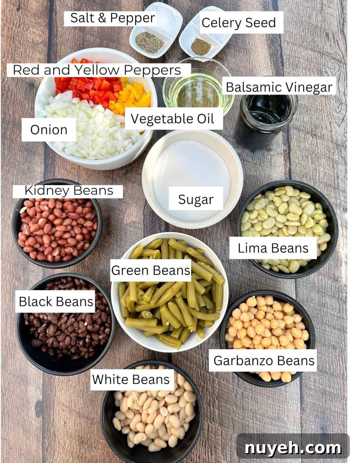 Cold Green Bean Salad ingredients arranged in individual bowls on a table with labels on each ingredient.