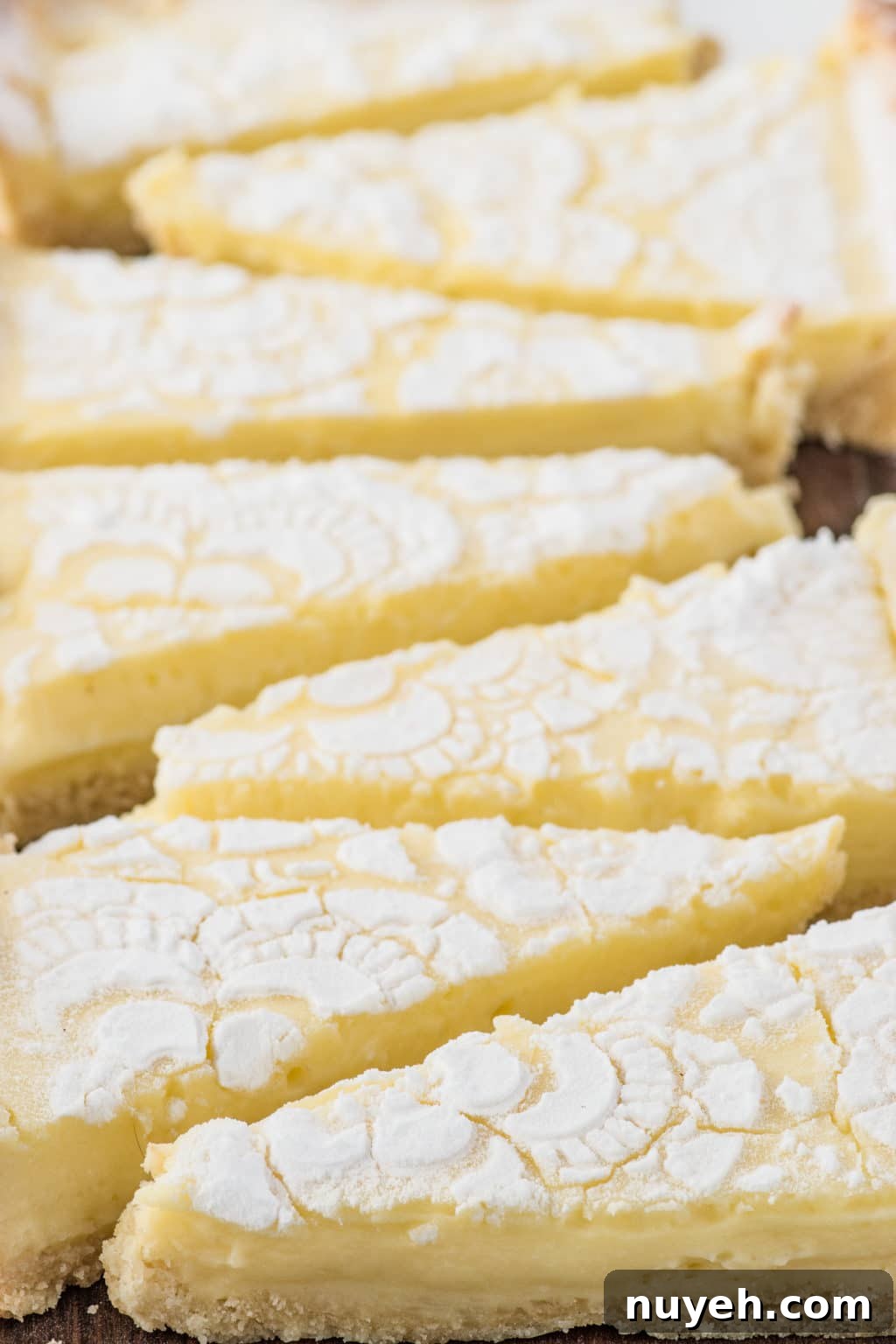 Triangular slices of bright yellow lemon tart 