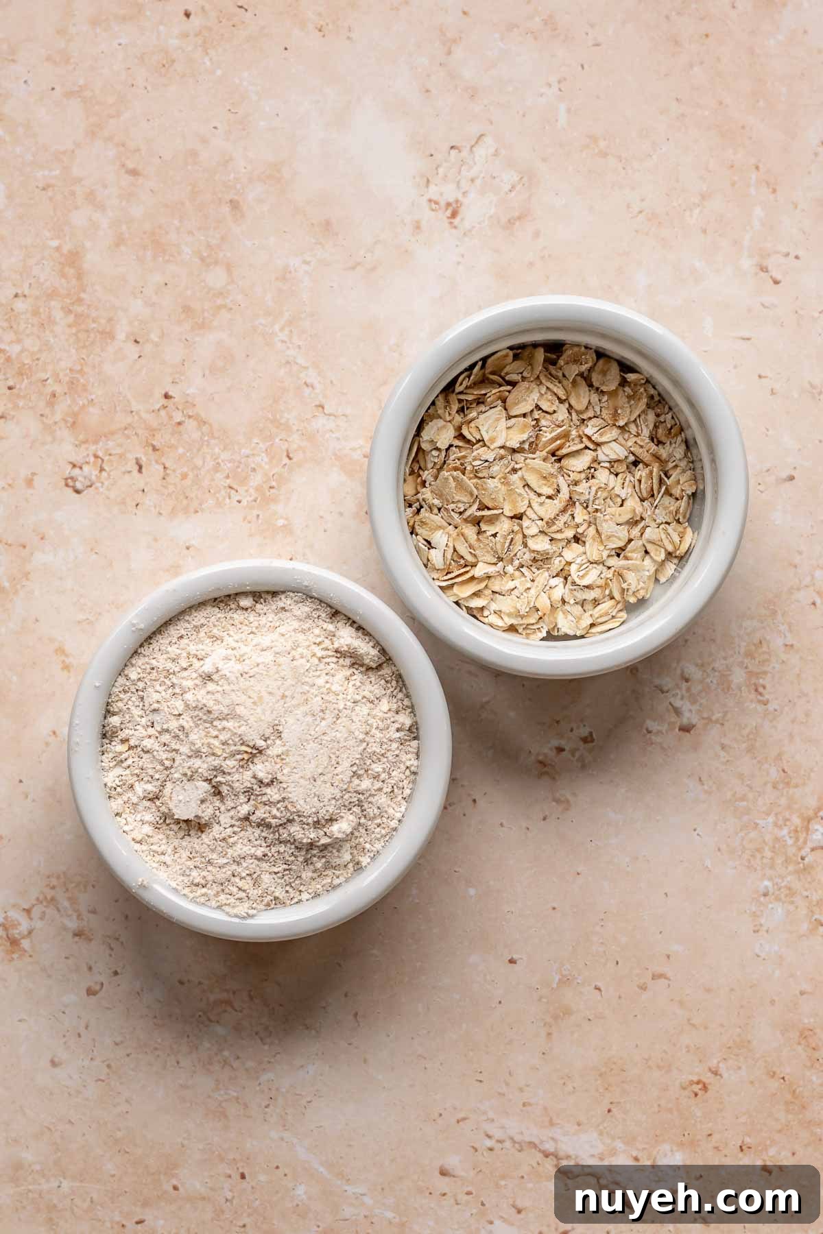 Two bowls of oats, one pulverized, one whole.