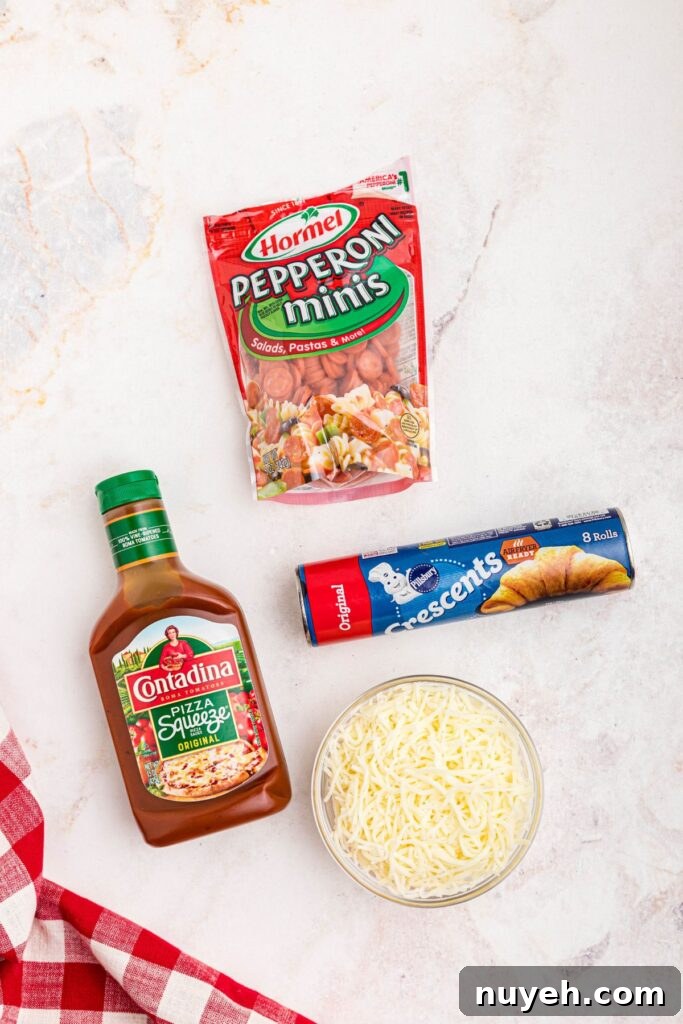 Pizza Cupcakes Recipe: Savory Mini Pizza Bites 3 Ingredients needed to make pizza cupcakes on a marble table.