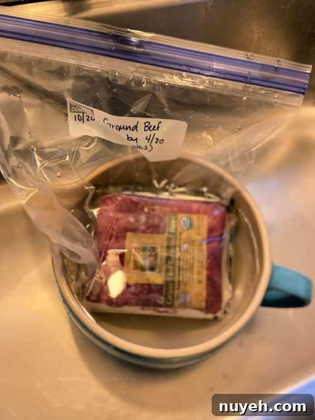 How to Thaw Ground Beef Safely: Refrigerator, Cold Water, Microwave 4 package of ground beef soaking in a bowl of water