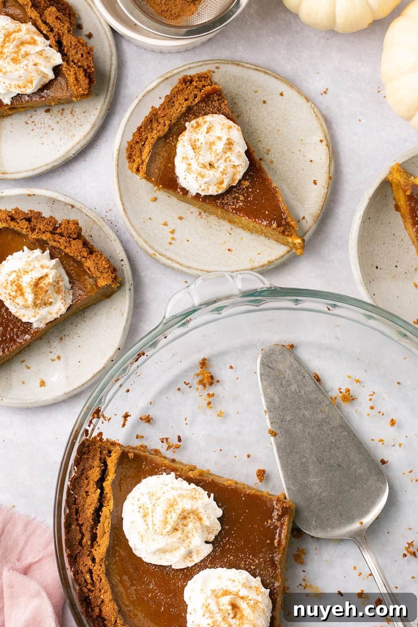 and overhead view of 4 white plates with slices of pumpkin pie topped with whipped cream