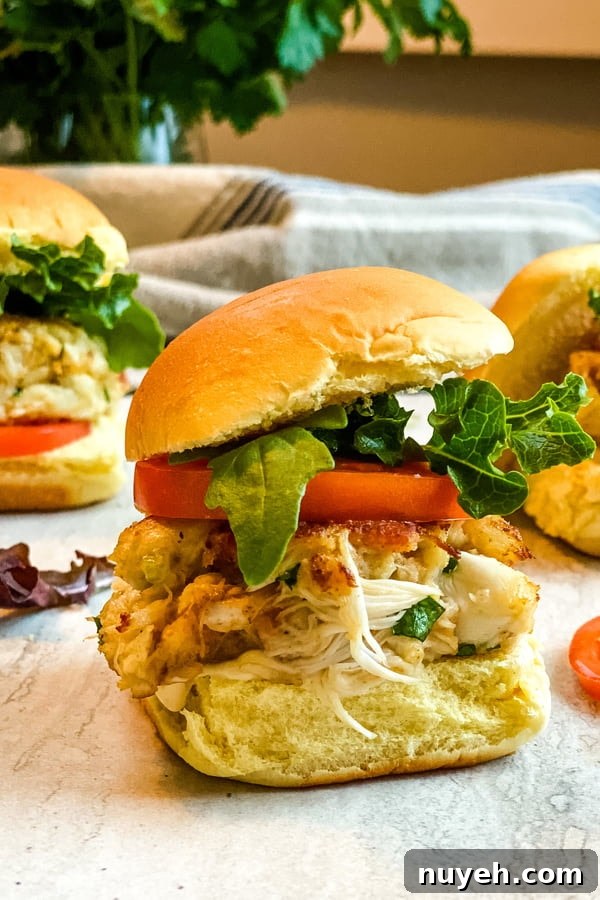 mini crab cake sandwiches with bacon, lettuce and tomato.