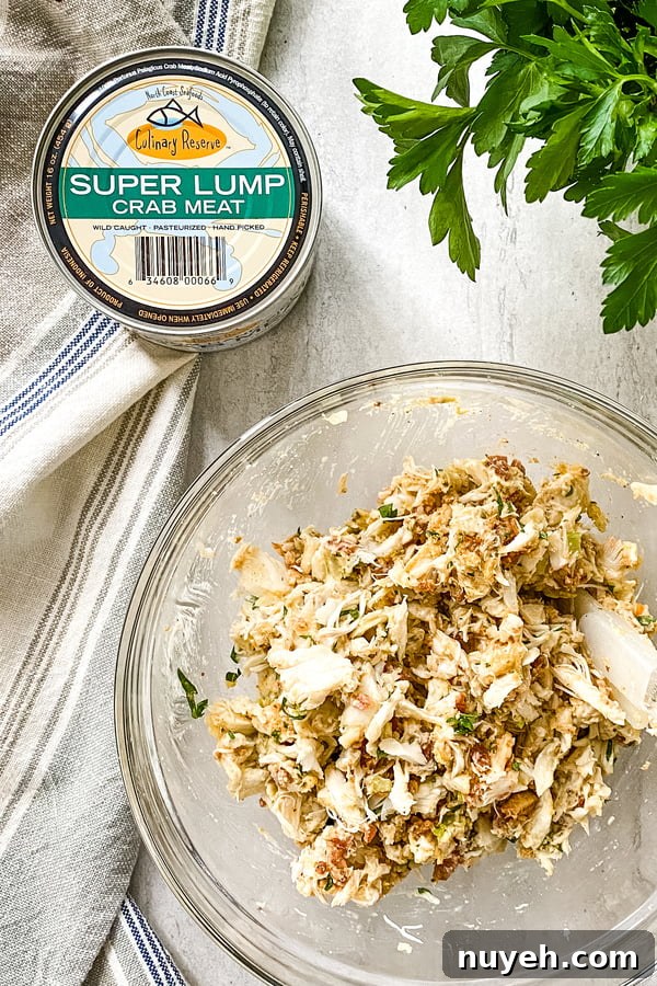 can of crab and ingredients in bowl for crab cakes.