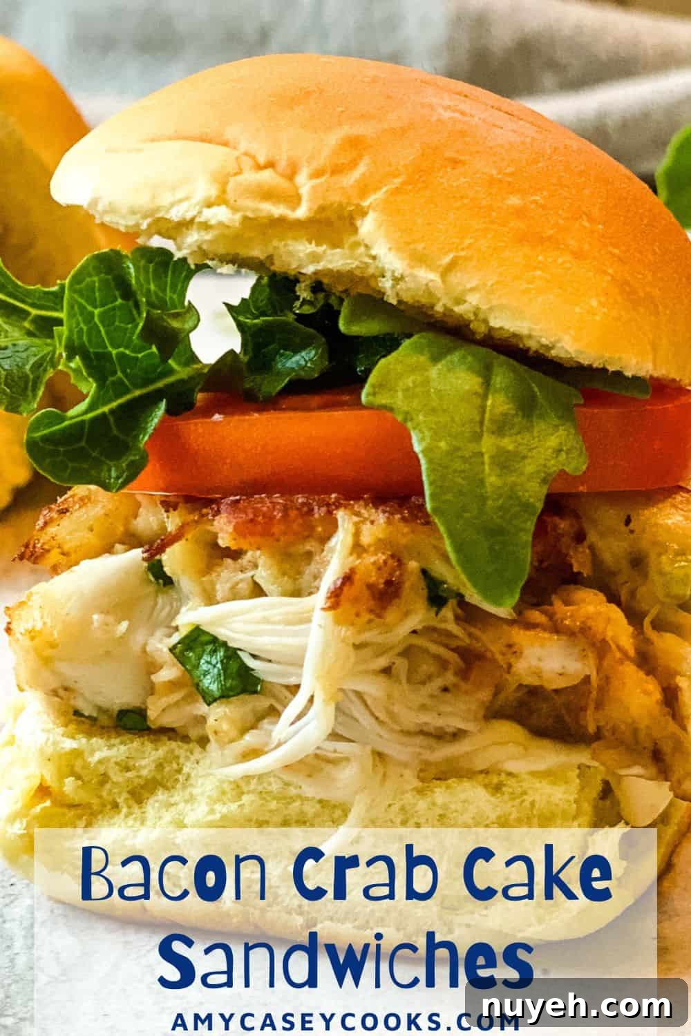 crab cake sandwich with bacon, lettuce and tomato.