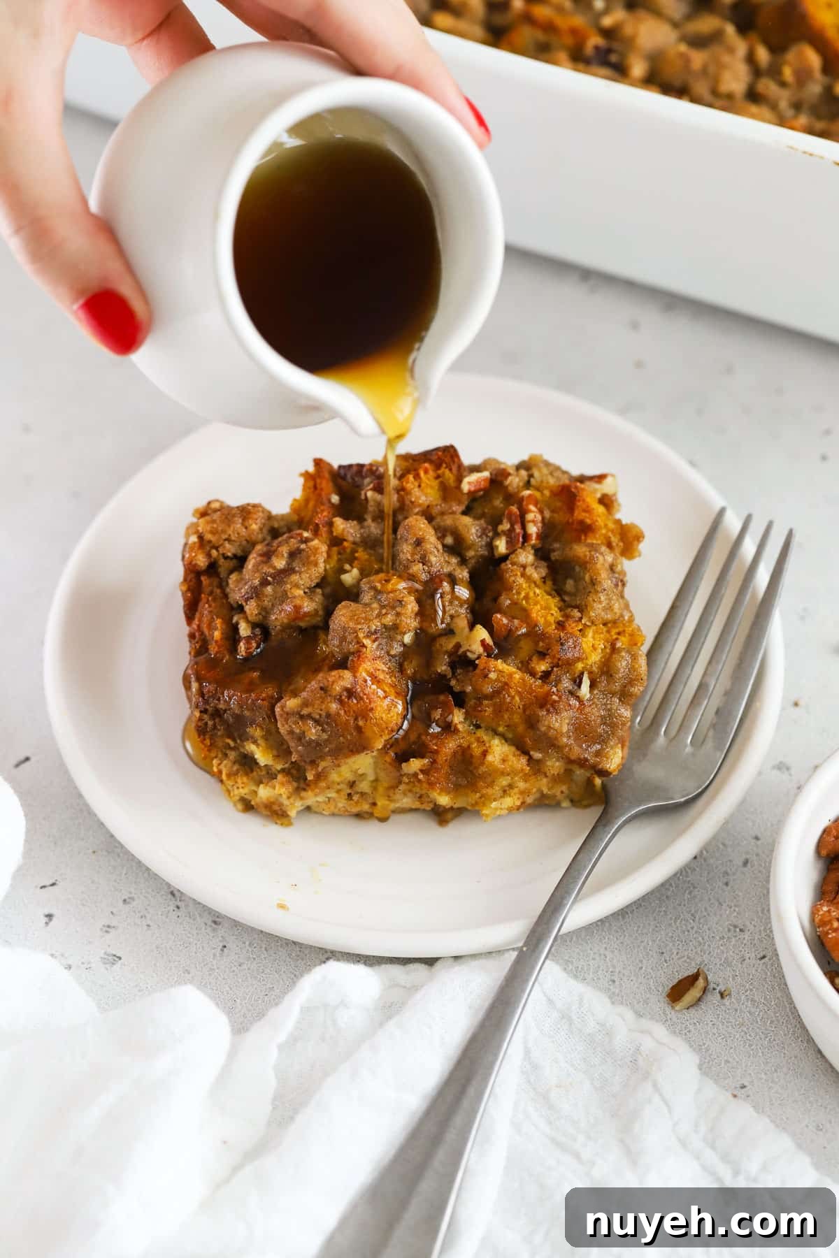 Gluten Free Pumpkin French Toast Casserole Recipe 2 Drizzling maple syrup over gluten-free pumpkin french toast casserole