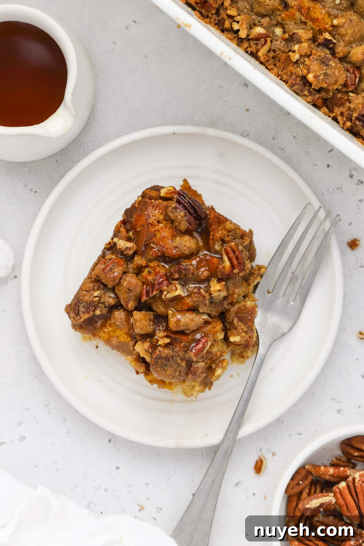 Gluten Free Pumpkin French Toast Casserole Recipe 7 A plate of pumpkin french toast casserole drizzled with maple syrup