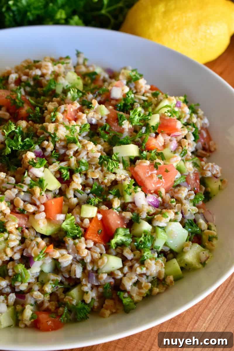 Farro Tabbouleh SAlad in a white bowl. 
