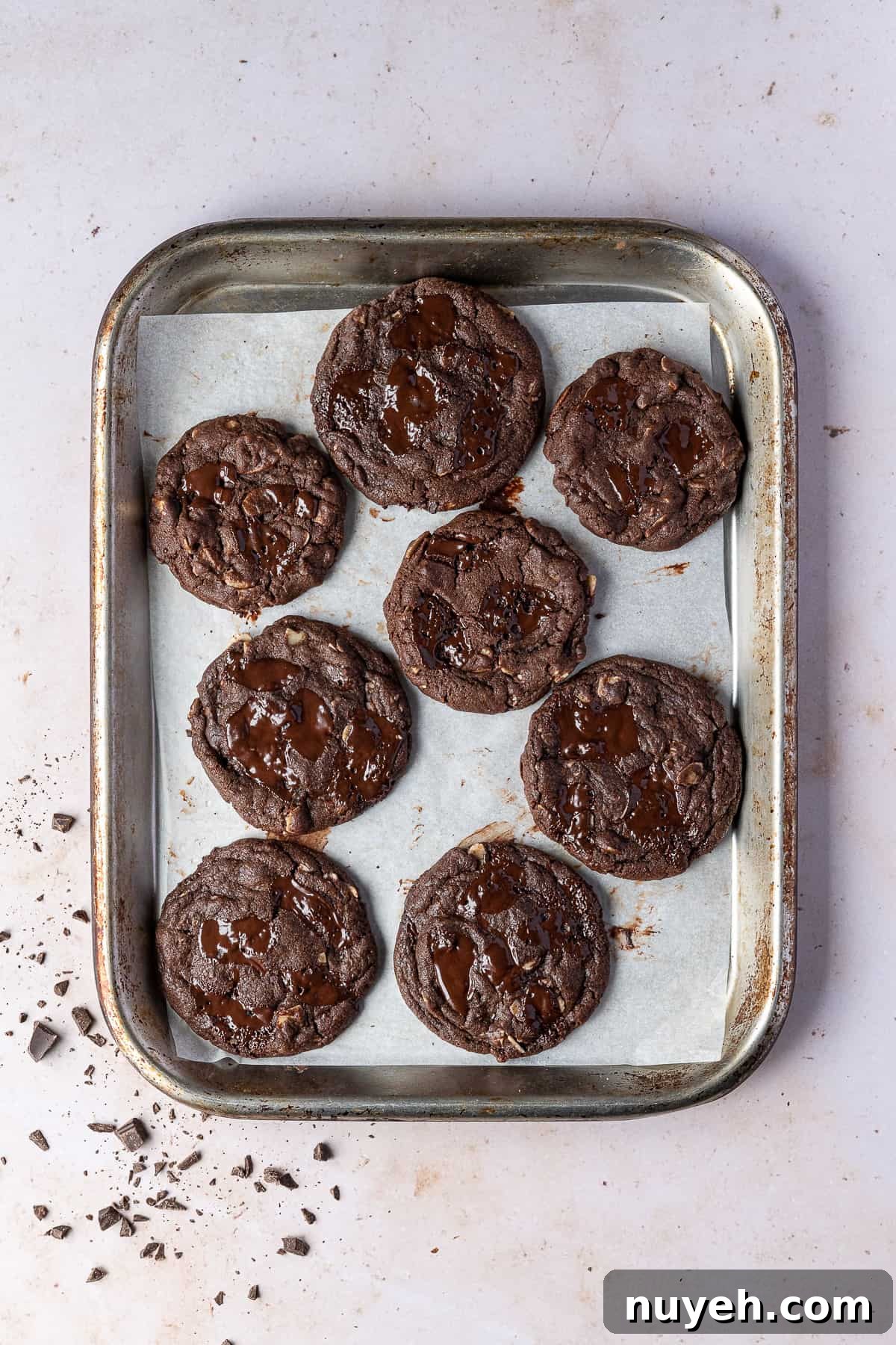 Vegan double chocolate almond cookies on a metal baking tray.