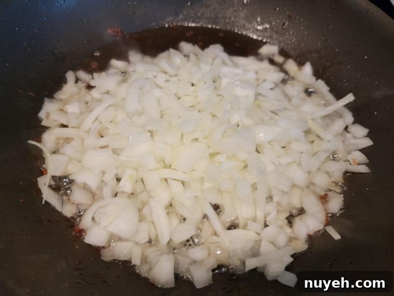 Onions in bacon grease in a frying pan