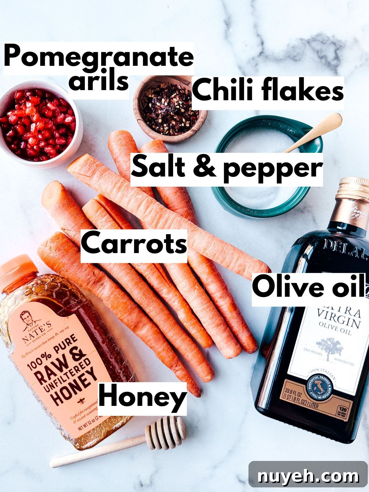 Ingredients for roasted carrots on marble background.