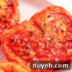 Air fryer tomatoes on a white plate.
