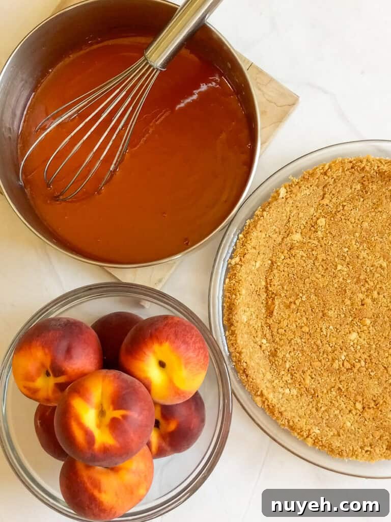 peach sauce in a saucepan, peaches in a bowl, and a graham cracker crust.