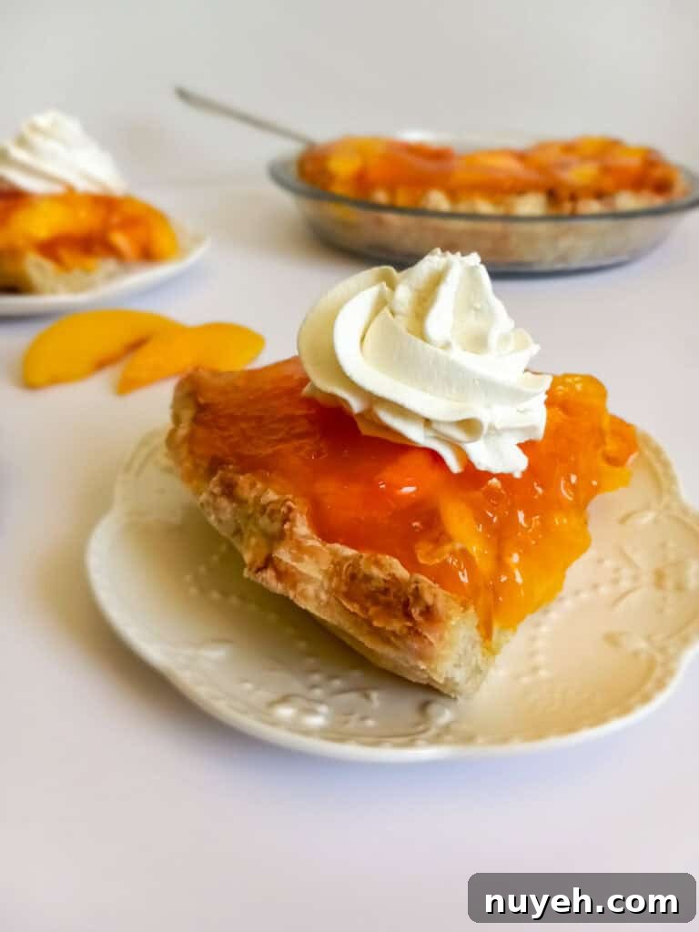 a slice of fresh peach pie with a flaky crust.
