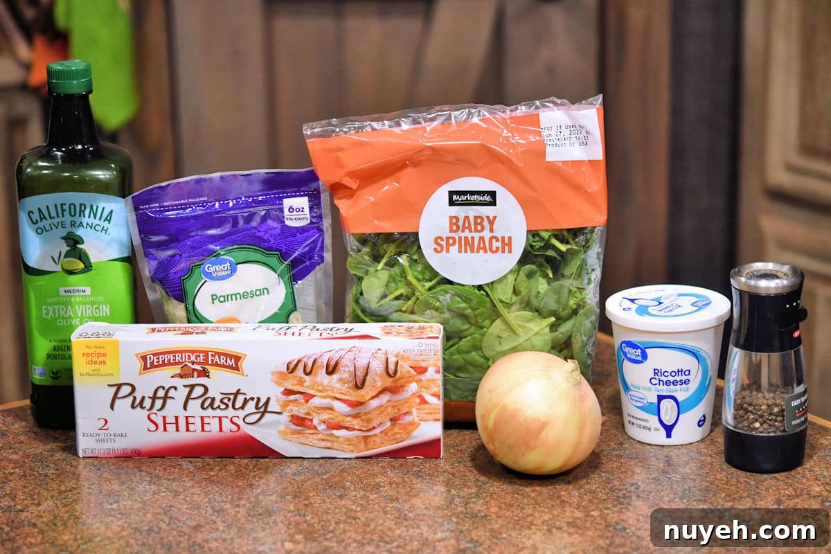 ingredients for spinach ricotta puff pastry on a countertop