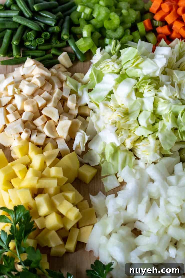 Cutting board filled with prepped and chopped vegetables.