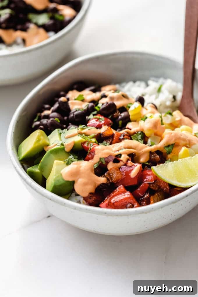 a vegan burrito bowl topped with chipotle crema