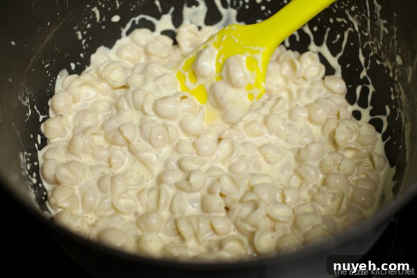 Stirring cauliflower into mac and cheese