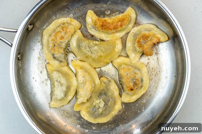 Authentic Polish Sauerkraut and Mushroom Pierogi Recipe 10 Frying the pierogi
