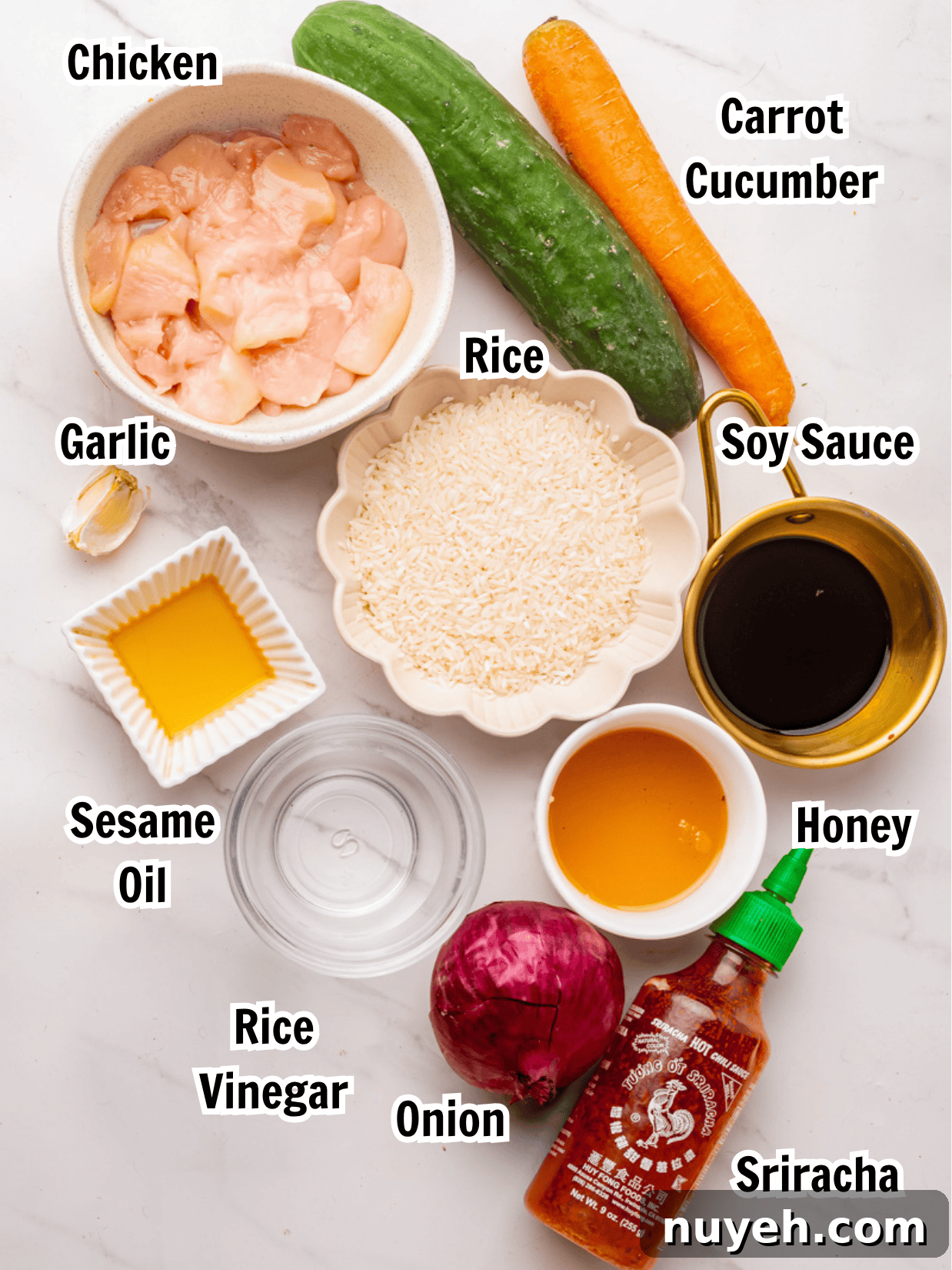ingredients including chicken, rice, soy sauce, sesame oil, honey,  rice vinegar, sriracha, cucumber, and carrots.