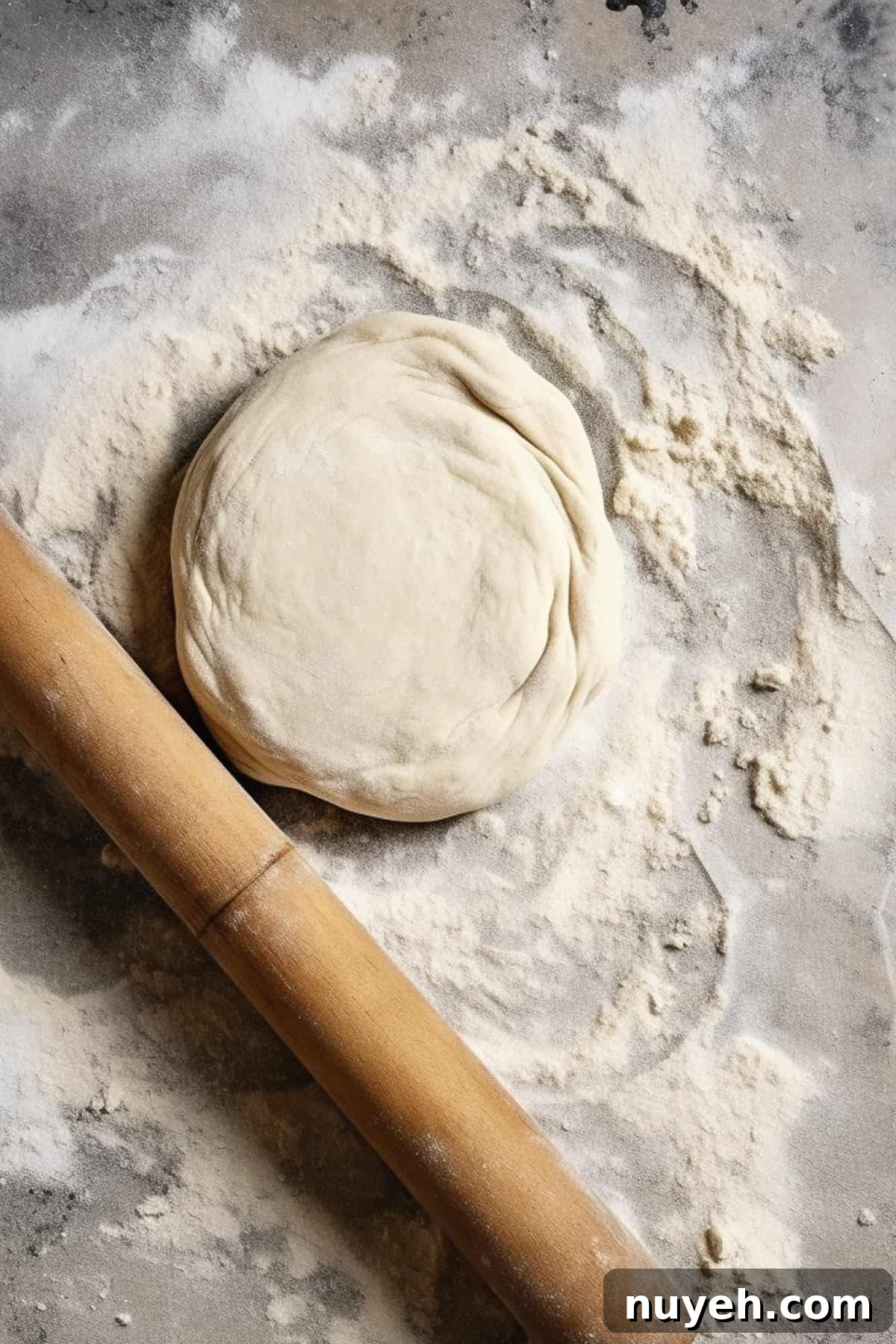 No-yeast naan dough being rolled out on a table.