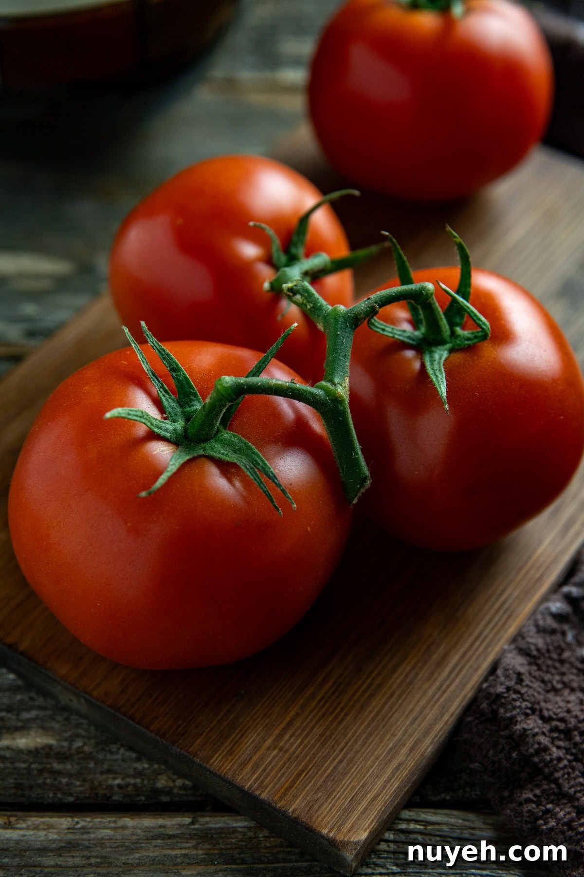 A cluster of fresh tomatoes on the vine.