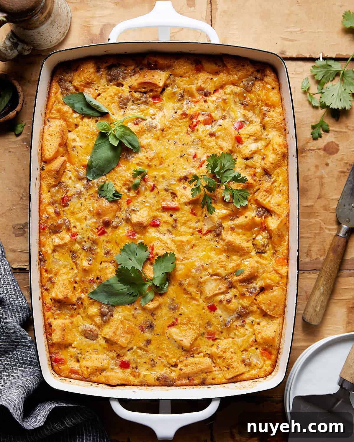 Egg sausage casserole in a white baking dish. 