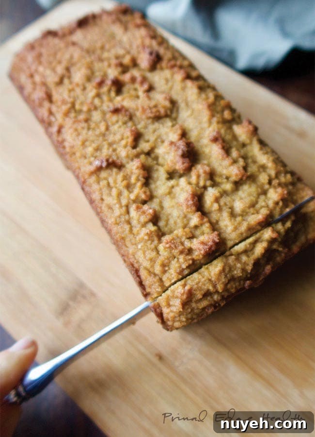 Ketogenic gingerbread loaf with one end being sliced.