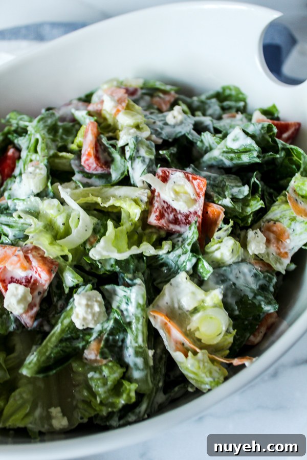 Crisp Green Salad with Creamy Yogurt Dressing 2 a close up picture of a large white bowl with green salad and creamy yogurt dressing