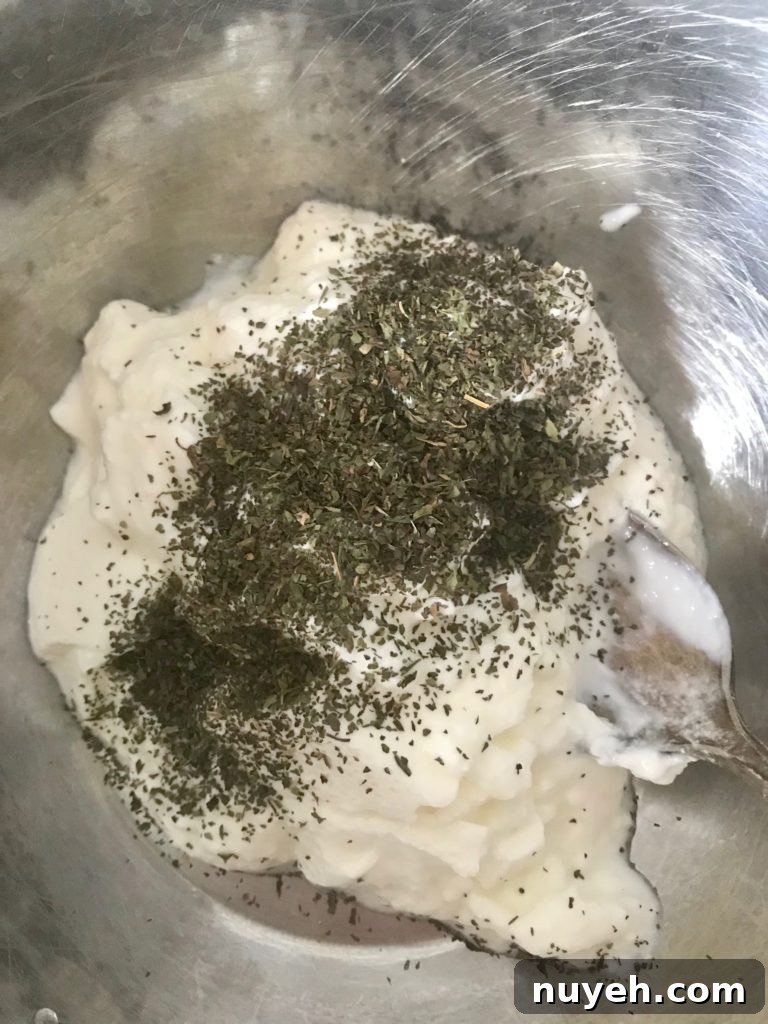 Crisp Green Salad with Creamy Yogurt Dressing 4 yogurt with dried parsley and mint on top of it in a bowl