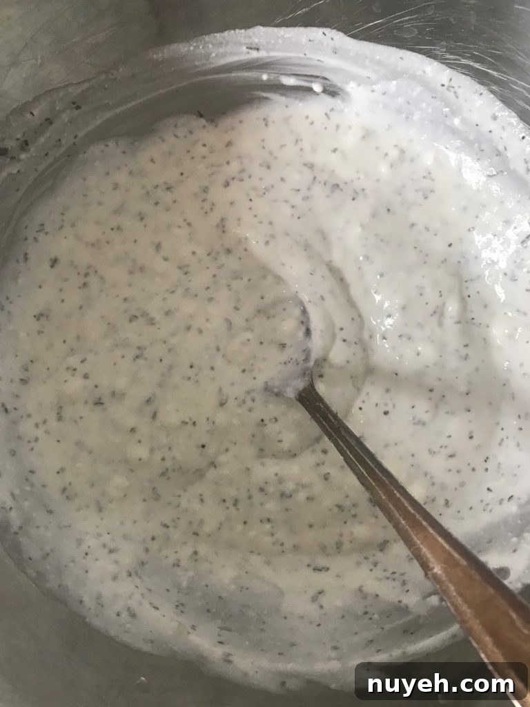 Crisp Green Salad with Creamy Yogurt Dressing 5 a mixing bowl with yogurt and dried herbs in it