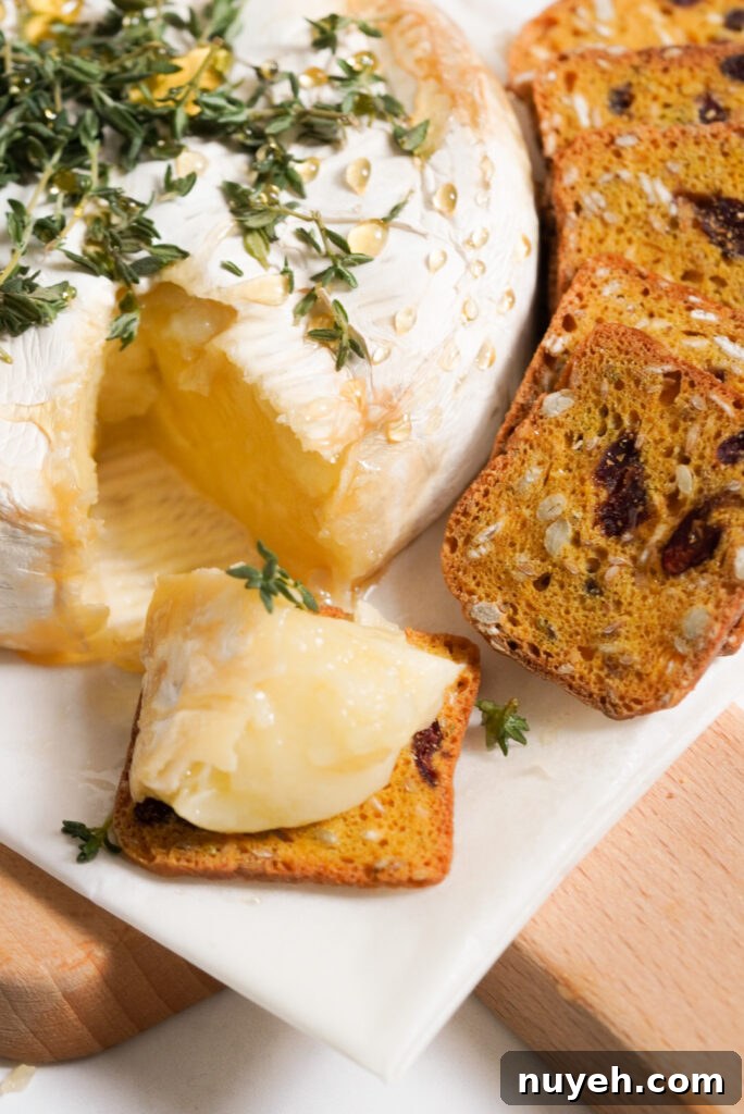 Air Fryer Baked Brie with Honey and Thyme 11 small dried fruit and nut toast topped with a small wedge of honey baked brie.