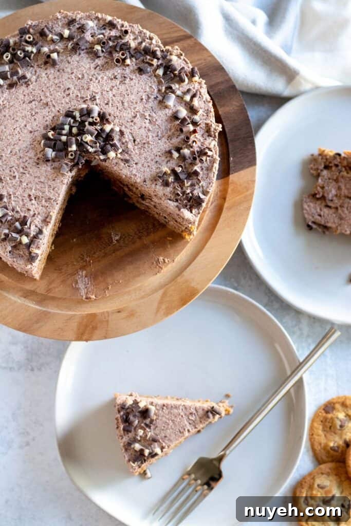 overhead view of cake on wood cake stand with slices on plates