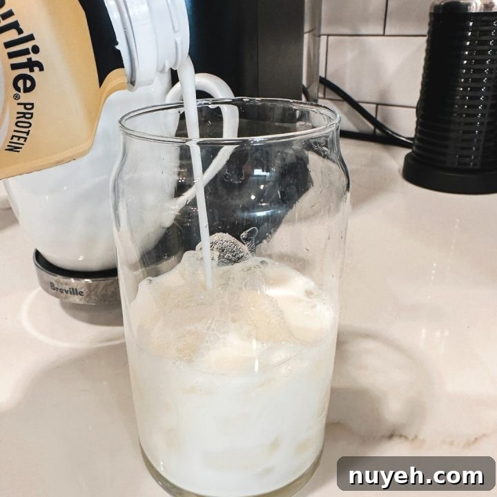 Fill a glass with ice cubes, leaving enough room at the top for your coffee and protein milk mixture. Pour part of the Fairlife Vanilla Power Core Shake over the ice.
