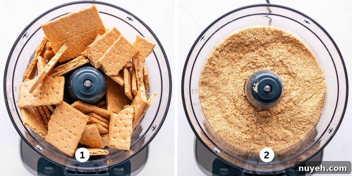 Pulverizing graham crackers into fine crumbs in a small food processor for cheesecake crust on a white background.