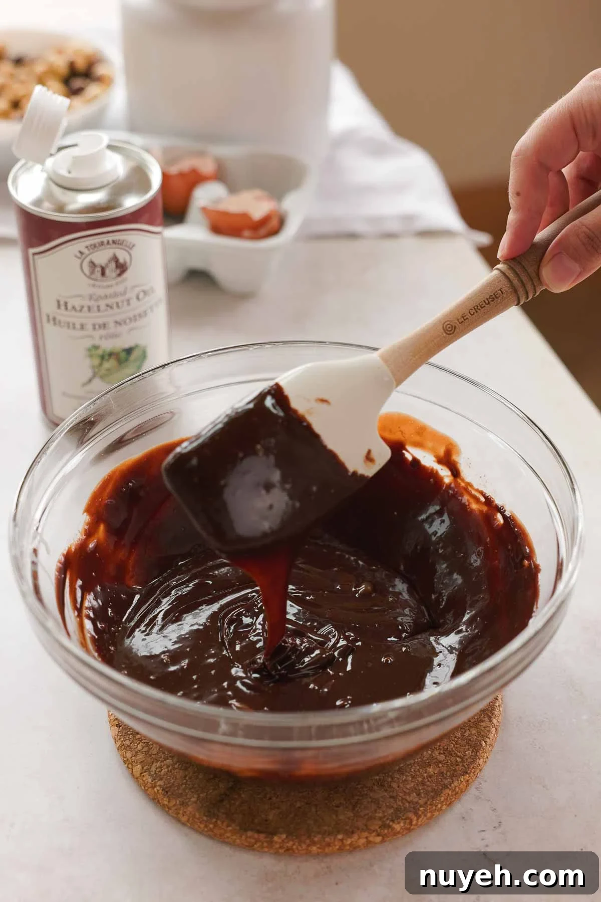 melted chocolate and hazelnut infused cream in large glass bowl