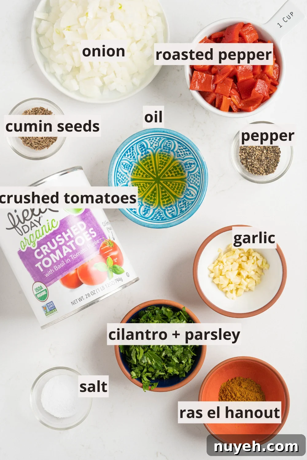 bowls of oil, peppers, spices, and more on a white counter