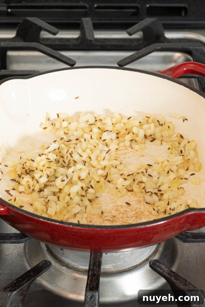 onions and cumin seeds in a pan