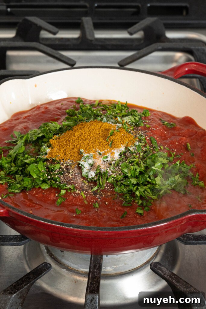 tomato sauce with herbs and spices in a pan