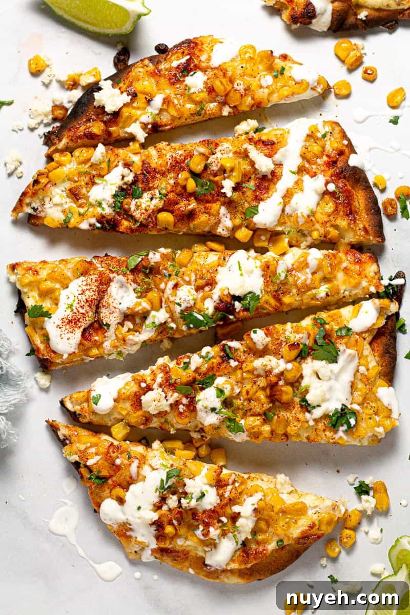 Overhead shot of Mexican street corn pizza garnished with fresh chopped cilantro 